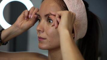 Side view brow massage with fingers during self care video