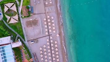Aerial view of Mediterranean beach resort with umbrellas and sandy shore video