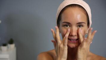 Applying facial cream with fingertips at home video
