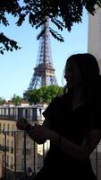 Silhouette woman adjusting sunglasses near Eiffel Tower video