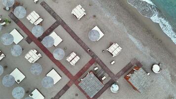 360 aerial view above beach cabanas and boardwalks by the sea video