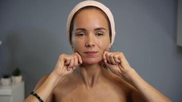 Chin and jawline massage with knuckles facing camera video