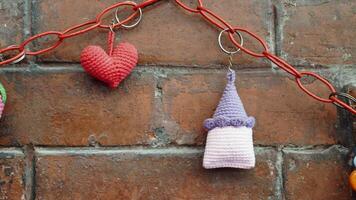 Handmade crochet keychains displayed on a brick wall video