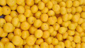 Fresh yellow lemons at local market in summer time video