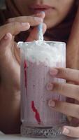 Enjoying a delicious milkshake in a cozy cafe setting video