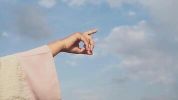 Hand pointing towards the sky on a cloudy day video