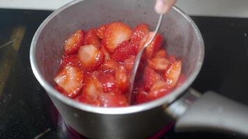 Cooking strawberry sauce on a stovetop video