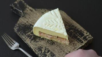 Piece of cheesecake with nuts, berries with winter pattern on dark concrete background video