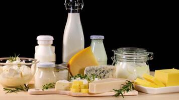 Assorted dairy products on a black background video