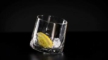 Lime and ice rotate inside a glass video