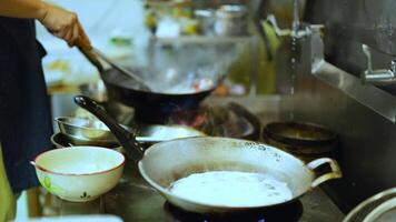 Chef skillfully cook with a wok in kitchen video