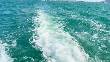 A boat travels through turquoise waters near Phuket, Thailand, under clear skies, creating a dynamic wake video