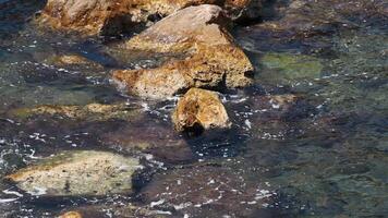 Ocean wave splashing against coastal rocks video