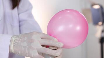 Demonstrating chemical reaction inflating a pink balloon video
