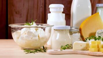 Assorted dairy items displayed on wooden surface and background video