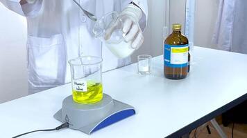 Scientist conducts iodine clock reaction using vitamin C and starch in a laboratory setting with controlled lighting video