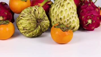 Assorted fruits displayed on a white surface video
