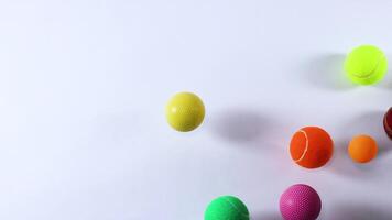 Various ball moving across a white background video