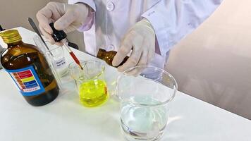 A scientist conducts an iodine clock reaction, mixing chemicals in a lab setting with precise measurements and controlled lighting video