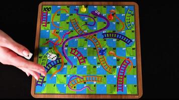 Rolling dice and moving pieces on board video