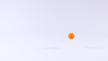 Orange ball bouncing on a white surface video