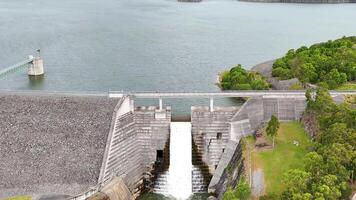 Water flows steadily over the dam wall video