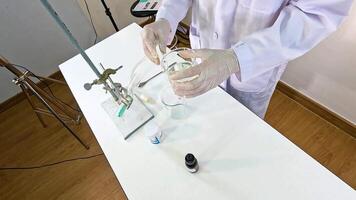Scientist conducts a chemical reaction between copper carbonate and sulfuric acid in a laboratory setting video