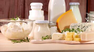 Various dairy items displayed on a wooden surface and wooden background video