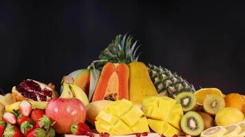 Various fresh fruits on black background video