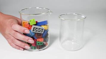 Moving colorful blocks from one glass to another video