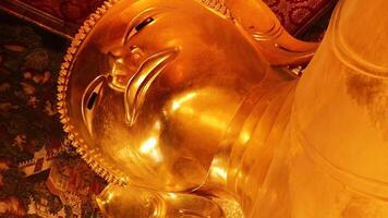 Golden statue of reclining Buddha in Bangkok video