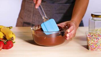 Chocolate with spatula, fruits, and sprinkles video