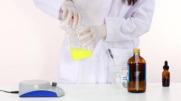 Scientist demonstrates iodine clock reaction experiment with laboratory equipment video