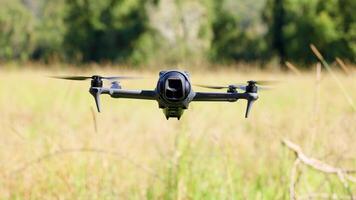 Drone flies and hovers over grassy field video