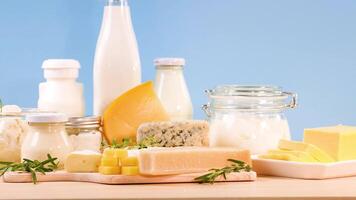 Assorted dairy items displayed against a blue backdrop video