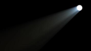 spotlight, light beam shining down on dark background. video
