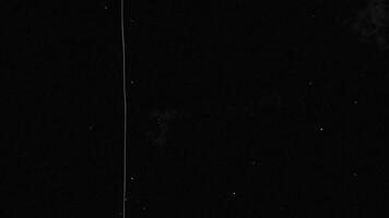 A plane flying in the dark with a long line video