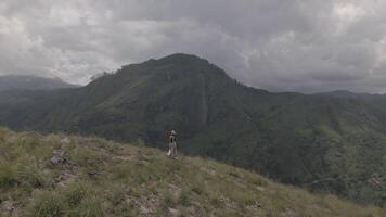 woman stand on viewpoint enjoy panorama scenery with beautiful mountains background video