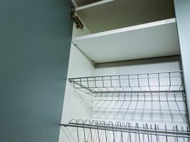 This image showcases a detailed closeup view of a wire rack that is located inside a cabinet, emphasizing its structure and utility in organizing household items effectively photo