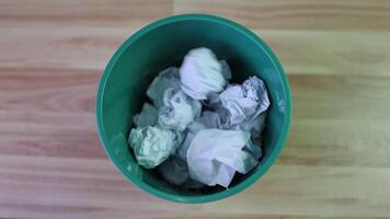 throw crumpled paper ball into a trash can, paper waste, trash bin in office with crumple paper ball, work hard, creative ideas concept video