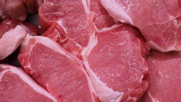 fresh pork closely arranged with clear detail of the pork. suitable for food advertising, fresh pork in markets, meat processing industry, displayed in frozen tray fresh food supermarket, close-up. video