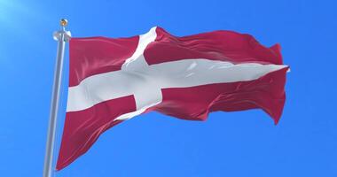 Denmark flag waving at wind with blue sky, loop video