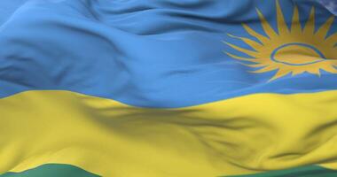Rwanda flag waving at wind in slow with blue sky, loop video