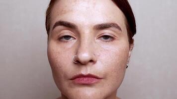 Caucasian woman face with pigmentation, melasma, freckles, age spots photo. Close up footage video