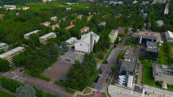 Aerial view of Saint Barbara Square in front of the Parish of Santa Barbara of San Donato Milanese Flight over the city. Milan. Italy, video