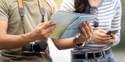 Travel Planning. Close-up of hands holding a map and smartphone. photo
