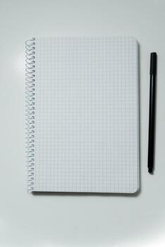 notebook with pencil. school notebook on white background, spiral notepad on table photo