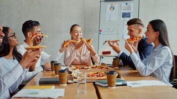 In a contemporary workspace, a diverse group of professionals shares pizza while discussing strategies. Charts and graphs are visible on the whiteboard, indicating a focus on business growth. video
