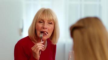 A group of family members enjoys a Thanksgiving meal together at home. Laughter and cheerful conversations fill the air as delicious food is served at the table. video