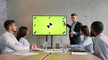 A professional multiethnic team collaborates in an office, focusing on a presentation. The team is engaged, discussing innovative ideas related to business success. video
